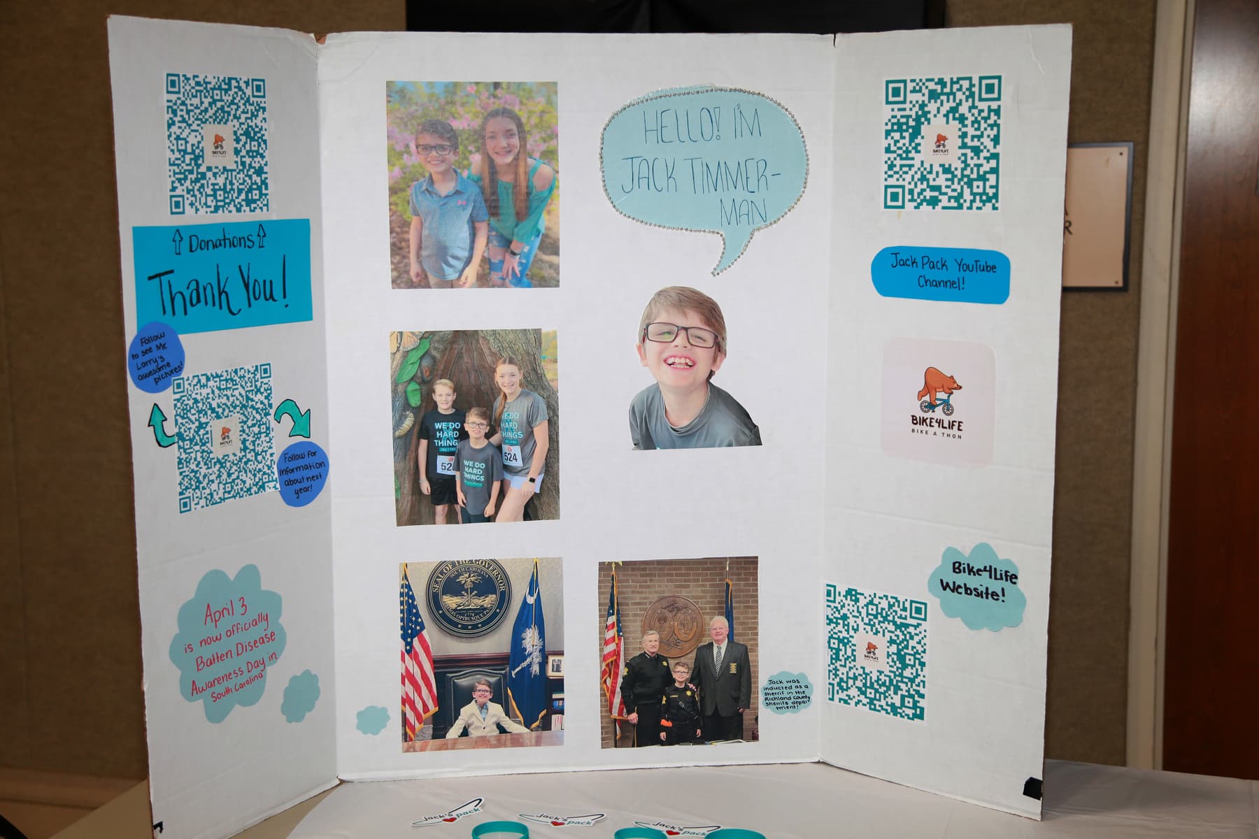 A handcrafted display board sharing Jack Timmerman's story and Bike4Life links