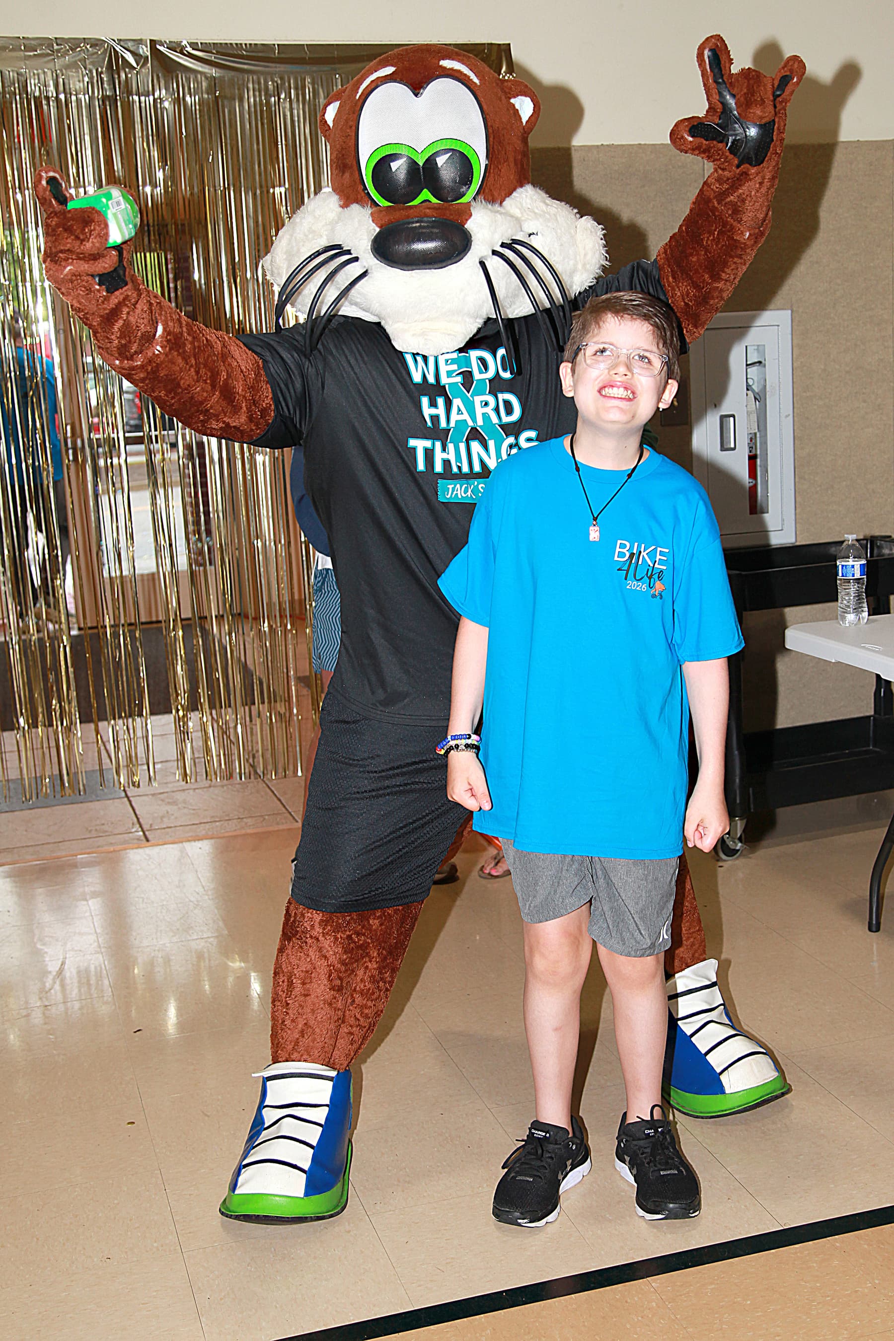 Bike4Life rider posing with the event mascot
